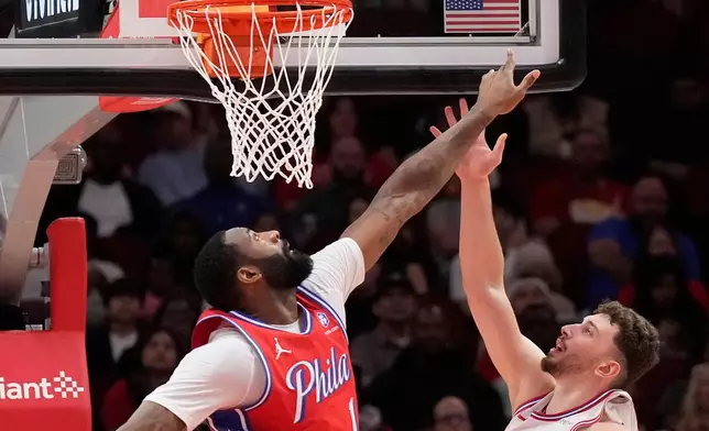 Philadelphia 76ers forward Andre Drummond (1) defends the basket against Houston Rockets center Alperen Sengun (28) during the first half of an NBA basketball game, Thursday, April 9, 2026, in Houston. (AP Photo/ Karen Warren)