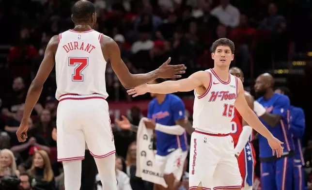 Houston Rockets' Reed Sheppard (15) celebrates one of his three point baskets with Kevin Durant (7) during the first half of an NBA basketball game against the Philadelphia 76ers, Thursday, April 9, 2026, in Houston. (AP Photo/ Karen Warren)