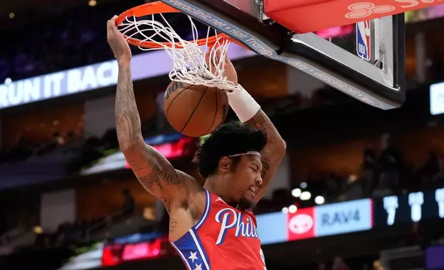 Philadelphia 76ers forward Kelly Oubre Jr. (9) dunks the ball during the first half of an NBA basketball game against the Houston Rockets, Thursday, April 9, 2026, in Houston. (AP Photo/ Karen Warren)