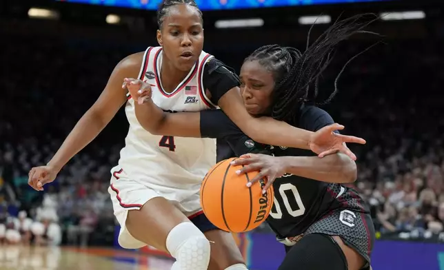 South Carolina guard Ta'Niya Latson (00) drives against UConn guard Blanca Quinonez (4) during the second half of a woman's NCAA college basketball tournament semifinal game at the Final Four, Friday, April 3, 2026, in Phoenix. (AP Photo/Rick Scuteri)