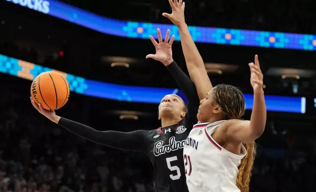 South Carolina guard Tessa Johnson (5) shoots over UConn forward Sarah Strong (21) during the second half of a woman's NCAA college basketball tournament semifinal game at the Final Four, Friday, April 3, 2026, in Phoenix. (AP Photo/Rick Scuteri)