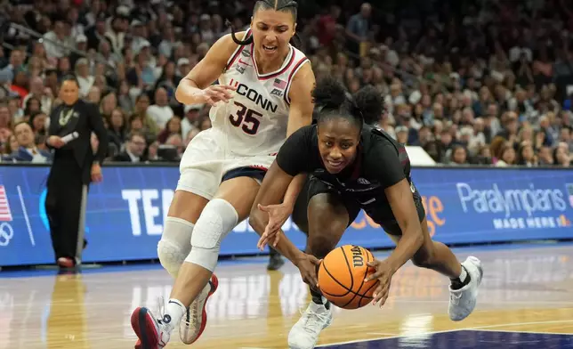 UConn guard Azzi Fudd (35) fouls South Carolina forward Joyce Edwards (8) during the second half of a woman's NCAA college basketball tournament semifinal game at the Final Four, Friday, April 3, 2026, in Phoenix. (AP Photo/Rick Scuteri)
