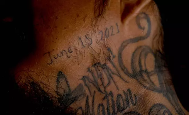 Gerald Begay, whose mother Ella Mae Begay went missing from her home, shows a neck tattoo memorializing her in his home in Denver, April 2, 2026. (AP Photo/Thomas Peipert)