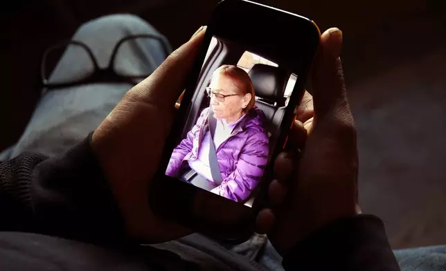 Gerald Begay, whose mother Ella Mae Begay went missing from her home, shows a photo of her on his phone in Denver, Thursday, April 2, 2026. (AP Photo/Thomas Peipert)