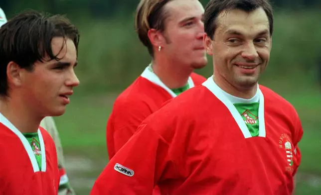 FILE -New Hungarian Prime Minister Dr. Viktor Orban smiles at fellow teammates at the end of the first half of play during a scrimage played at the Hungarian Sports Club in Woodbridge, N. J., Oct. 10, 1998. (AP Photo/Michael J.Treola, File)
