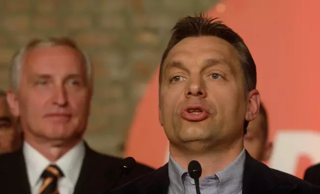 FILE -Viktor Orban, chairman of the senior opposition party, the Fidesz - Hungarian Civic Alliance, right, speaks following the first round of the parliamentary elections in Hungary in Budapest, April 9, 2006. At left is deputy prime minister candidate of the Fidesz, Istvan Mikola. (AP Photo/MTI, Szilard Koszticsak, File)