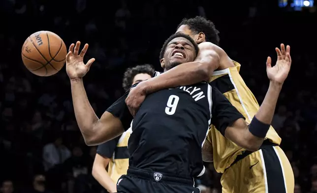 Brooklyn Nets forward E.J. Liddell (9) is fouled by Washington Wizards forward Julian "Juju" Reese (15) during the first half of an NBA basketball game, Sunday, April 5, 2026, in New York. (AP Photo/Angelina Katsanis)