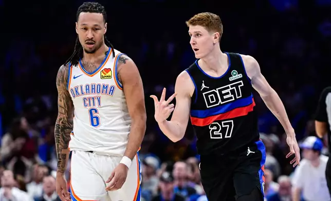 Detroit Pistons guard/forward Kevin Huerter (27) celebrates against Oklahoma City Thunder forward Jaylin Williams (6) during the second half of an NBA basketball game Monday, March. 30, 2026, in Oklahoma City. (AP Photo/Gerald Leong)