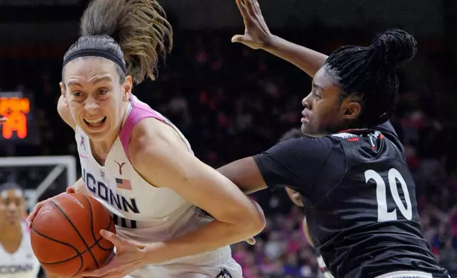 FILE - Connecticut's Breanna Stewart, left, drives to the basket as Cincinnati's Maya Benham, right, defends during the first half of an NCAA college basketball game Wednesday, Feb. 17, 2016, in Storrs, Conn. (AP Photo/Jessica Hill, File)