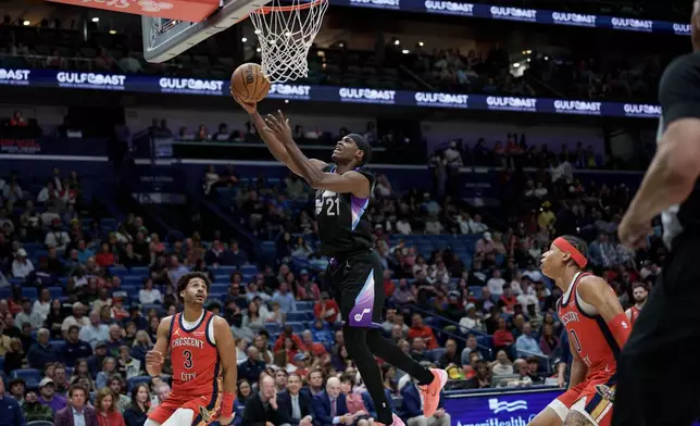 Utah Jazz guard Bez Mbeng (21) shoots against New Orleans Pelicans guard Jordan Poole (3) of an NBA basketball game in New Orleans, Tuesday, April 7, 2026. (AP Photo/Matthew Hinton)
