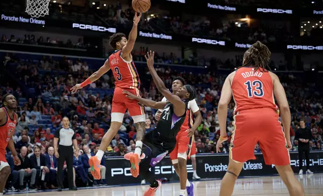 New Orleans Pelicans guard Jordan Poole (3) blocks the shot of Utah Jazz guard Bez Mbeng (21) during the first half of an NBA basketball game in New Orleans, Tuesday, April 7, 2026. (AP Photo/Matthew Hinton)