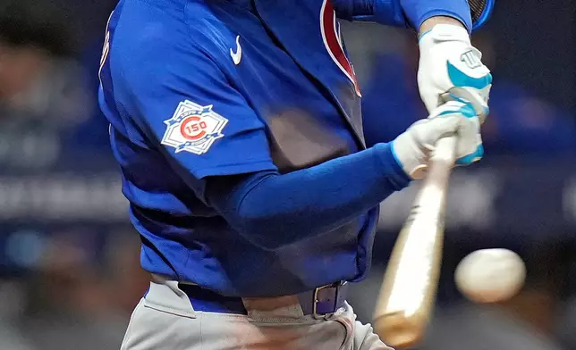 Chicago Cubs' Alex Bregman connects for a single off Tampa Bay Rays pitcher Cole Sulser during the fifth inning of a baseball game Tuesday, April 7, 2026, in St. Petersburg, Fla. (AP Photo/Chris O'Meara)
