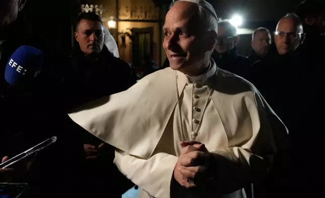 Pope Leo XIV talks to journalists as he leaves his residence in Castel Gandolfo, on the outskirts of Rome, to return to the Vatican, Tuesday, March 31, 2026. (AP Photo/Gregorio Borgia)
