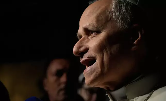 Pope Leo XIV talks to journalists as he leaves his residence in Castel Gandolfo, on the outskirts of Rome, to return to the Vatican, Tuesday, March 31, 2026. (AP Photo/Gregorio Borgia)