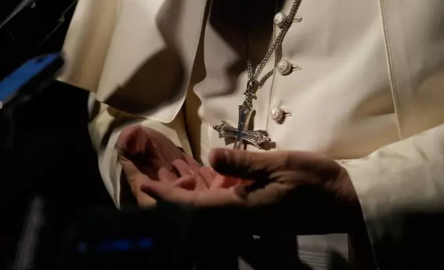 Pope Leo XIV talks to journalists as he leaves his residence in Castel Gandolfo, on the outskirts of Rome, to return to the Vatican, Tuesday, March 31, 2026. (AP Photo/Gregorio Borgia)