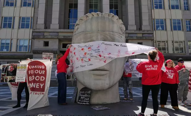 People rally outside a courthouse while a hearing for Purdue Pharma takes place inside in Newark, N.J., Tuesday, April 21, 2026. (AP Photo/Seth Wenig)