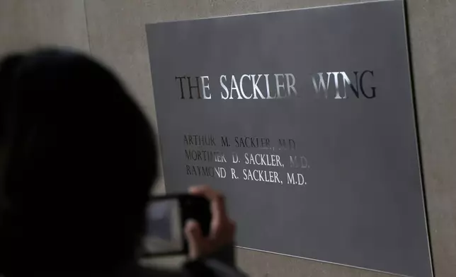 FILE - A sign with some names of the Sackler family is displayed at the Metropolitan Museum of Art Jan. 17, 2019, in New York. (AP Photo/Seth Wenig, File)
