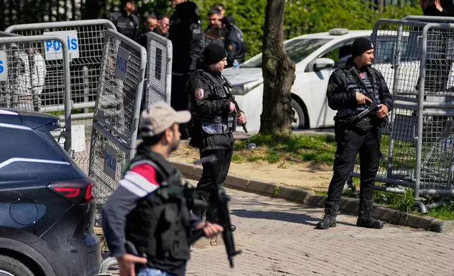 Turkish police secure the area after a gunmen attack at a building housing the Israeli Consulate in Istanbul, Turkey, Tuesday, April 7, 2026. (AP Photo/Khalil Hamra)