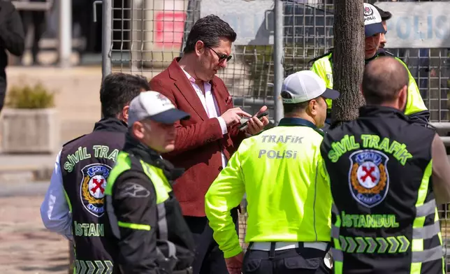Turkish police secure the area after a gunmen attack at a building housing the Israeli Consulate in Istanbul, Turkey, Tuesday, April 7, 2026. (Omer Hamza Yildiz/DIA Photo via AP)