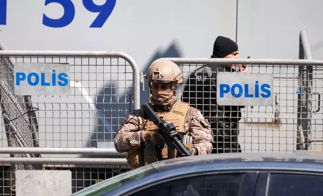 A Turkish soldier stands guard as police and soldiers secure the area after an attack by gunmen at a building housing the Israeli Consulate in Istanbul, Turkey, Tuesday, April 7, 2026. (Omer Hamza Yildiz/DIA Photo via AP)