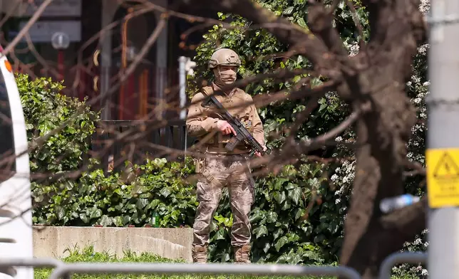 A Turkish soldier stands guard as police and soldiers secure the area after an attack by gunmen at a building housing the Israeli Consulate in Istanbul, Turkey, Tuesday, April 7, 2026. (Omer Hamza Yildiz/DIA Photo via AP)