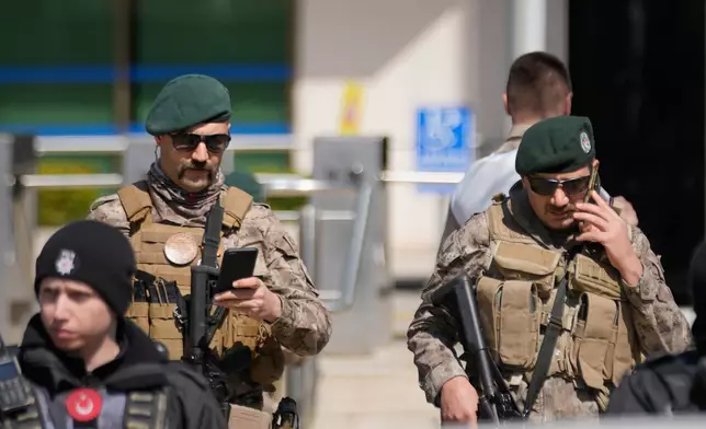 Turkish police and army secure the area after a gunmen attack at a building housing the Israeli Consulate in Istanbul, Turkey, Tuesday, April 7, 2026. (AP Photo/Khalil Hamra)