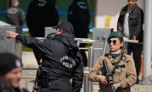 Turkish police and army secure the area after a gunmen attack at a building housing the Israeli Consulate in Istanbul, Turkey, Tuesday, April 7, 2026. (AP Photo/Khalil Hamra)