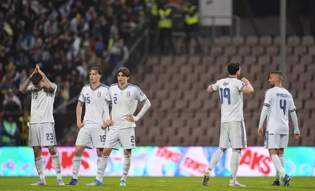 Italy players react after losing in a World Cup qualifying playoff final soccer match between Bosnia and Italy in Zenica, Bosnia, Tuesday, March 31, 2026. (Fabio Ferrari/LaPresse via AP)