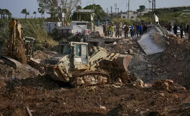 Lebanese army bulldozers reconstruct part of a destroyed bridge that was hit in an Israeli airstrike in Qasmiyeh near Tyre city, south Lebanon, to facilitate the return of displaced people to their villages following a ceasefire between Hezbollah and Israel, Friday, April 17, 2026. (AP Photo/Mohammed Zaatari)