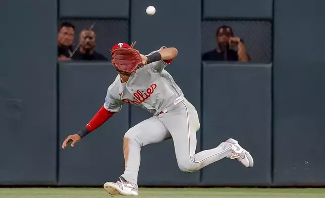 Philadelphia Phillies center fielder Justin Crawford (2) catches a fly ball hit by Atlanta Braves Drake Baldwin during the sixth inning of a baseball game, Friday, April 24, 2026, in Atlanta. (AP Photo/Erik S. Lesser)