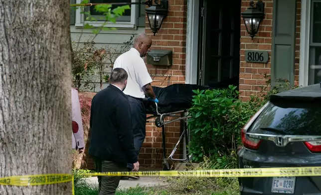 Fairfax County coroners remove a body from the home of former Virginia Lt. Gov. Justin Fairfax, in Annandale, Va., Thursday, April 16, 2026. (AP Photo/Cliff Owen)