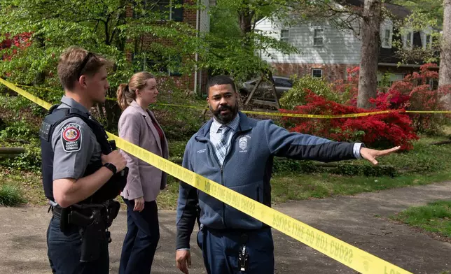 Fairfax County police confer in front of the home of former Virginia Lt. Gov. Justin Fairfax, in Annandale, Va., Thursday, April 16, 2026. (AP Photo/Cliff Owen)