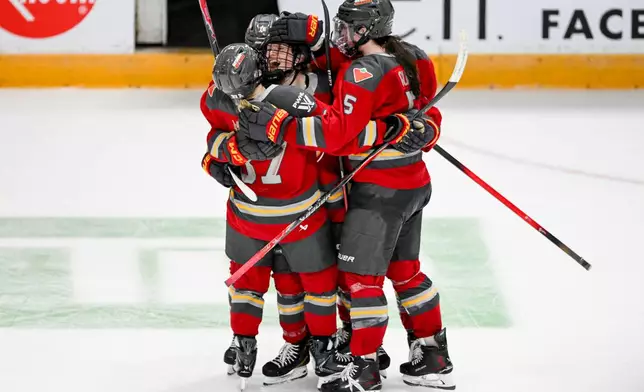 Ottawa Charge's Alexa Vasko, center, celebrates with teammates after her empty-net goal against the Toronto Sceptres during third-period PWHL hockey game action in Ottawa, Ontario, Saturday, April 25, 2026. (Spencer Colby/The Canadian Press via AP)