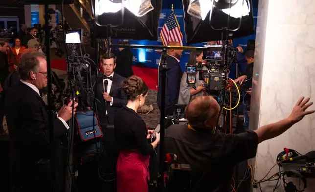 Journalists that were in attendance for the White House Correspondents Dinner work following a press briefing at the Washington Hilton following an incident that disrupted the event, Saturday, April 25, 2026, in Washington. (AP Photo/Allison Robbert)