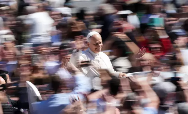 Pope Leo XIV greets the faithful at the end of Easter Mass he presided over in St. Peter's Square at the Vatican, Sunday, April 5, 2026. (AP Photo/Andrew Medichini)