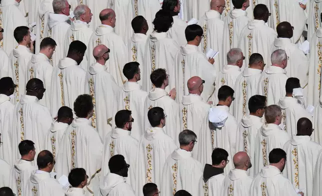 Clergy follow Pope Leo XIV as he presides over Easter Mass in St. Peter's Square at the Vatican, Sunday, April 5, 2026. (AP Photo/Alessandra Tarantino)