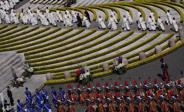 Priests reach toward the faithful to distribute Holy Communion as Pope Leo XIV presides over Easter Mass in St. Peter's Square at the Vatican, Sunday, April 5, 2026.(AP Photo/Alessandra Tarantino)