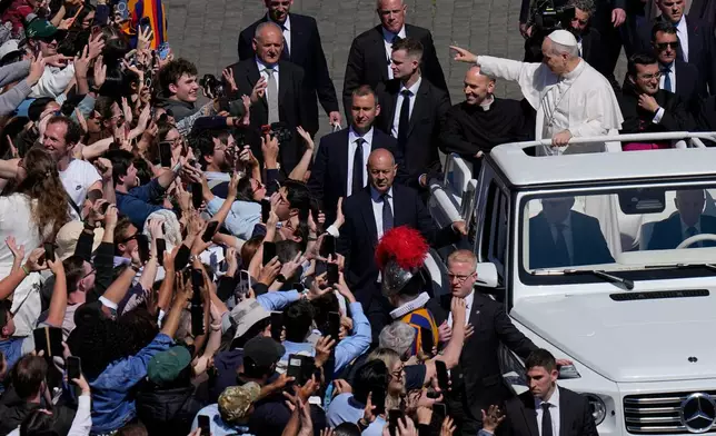 Pope Leo XIV greets the faithful at the end of Easter Mass he presided over in St. Peter's Square at the Vatican, Sunday, April 5, 2026. (AP Photo/Alessandra Tarantino)