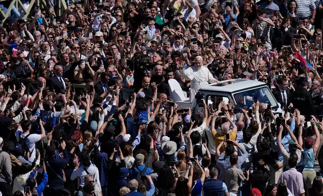Pope Leo XIV greets the faithful at the end of Easter Mass he presided over in St. Peter's Square at the Vatican, Sunday, April 5, 2026. (AP Photo/Alessandra Tarantino)