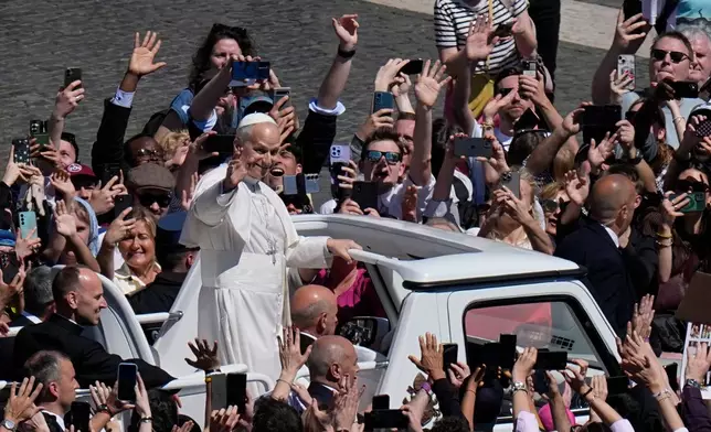 Pope Leo XIV greets the faithful at the end of Easter Mass he presided over in St. Peter's Square at the Vatican, Sunday, April 5, 2026. (AP Photo/Alessandra Tarantino)