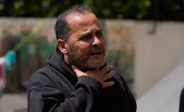 Ali al-Salim, who fled his southern hometown of Siddiqin for a school shelter in Haret Saida after an anonymous caller identifying himself as from the Israeli military urged him to flee, gestures during an interview with the Associated Press in the southern port city of Sidon, Lebanon, Tuesday, April 14, 2026. (AP Photo/Mohammed Zaatari)