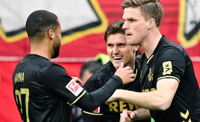 Cologne's Alessio Castro-Montes, center, celebrates with teammates after scoring during the German Bundesliga soccer match between Eintracht Frankfurt and 1. FC Cologne in Frankfurt, Germany, Sunday, April 5, 2026. (Uwe Anspach/dpa via AP)
