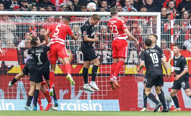 Union Berlin's Andrej Ilic, center right, scores during the Bundesliga soccer match between Union Berlin and St. Pauli, in Berlin, Sunday April 5, 2026. (Andreas Gora/dpa via AP)