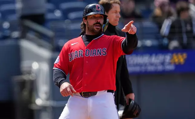 Cleveland Guardians' Austin Hedges gestures to first base as he scores on a single hit by Steven Kwan in the fifth inning of a baseball game against the Kansas City Royals in Cleveland, Tuesday, April 7, 2026. (AP Photo/Sue Ogrocki)