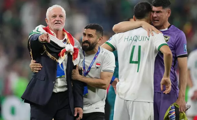 Iraq's coach Graham Arnold, left, celebrates as Bolivia's goalkeeper Carlos Lampe, right, comforts Luis Haquin after the World Cup playoff final soccer match between Iraq and Bolivia in Monterrey, Mexico, Tuesday, March 31, 2026. (AP Photo/Fernando Llano)