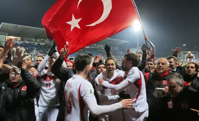 Turkey's players celebrate after winning the World Cup qualifying playoff final soccer match between Kosovo and Turkey in Pristina, Kosovo, Tuesday, March 31, 2026. (AP Photo/Visar Kryeziu)