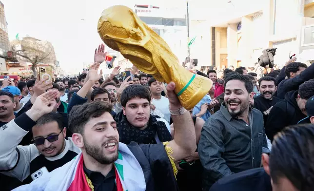 Soccer fans take to the streets of the enclave in Baghdad, Iraq, Wednesday, April 1, 2026, after the Iraq soccer team beat Bolivia in a World Cup 2026 playoff final. (AP Photo/Hadi Mizban)