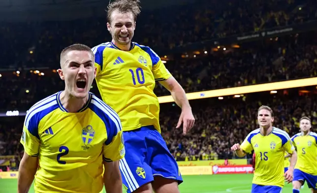 Sweden's Gustaf Lagerbielke, left, celebrates after scoring their second goal during a World Cup qualifying playoff final soccer match between Sweden and Poland in Stockholm, Tuesday, March 31, 2026. (Jonas Ekstromer/TT via AP)