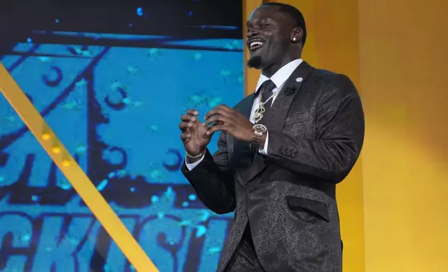 Notre Dame running back Jeremiyah Love reacts as he walks on stage before the first round of the NFL football draft, Thursday, April 23, 2026, in Pittsburgh. (AP Photo/Gene J. Puskar)