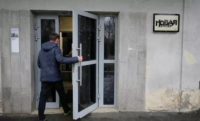 A man enters a building where independent Russian newspaper Novaya Gazeta has an office in Moscow, Thursday, April 9, 2026. (AP Photo/Pavel Bednyakov)